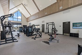 Gym with a variety of equipment including treadmills, weights, and exercise machines